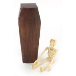 Japanese carved wood coffin enclosing an articulated bone skeleton, 11.5cm high