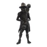Antique oak carving of a man holding a sack, 61cm high