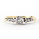 18ct gold and platinum diamond solitaire ring with diamond set shoulders, the diamond solitaire