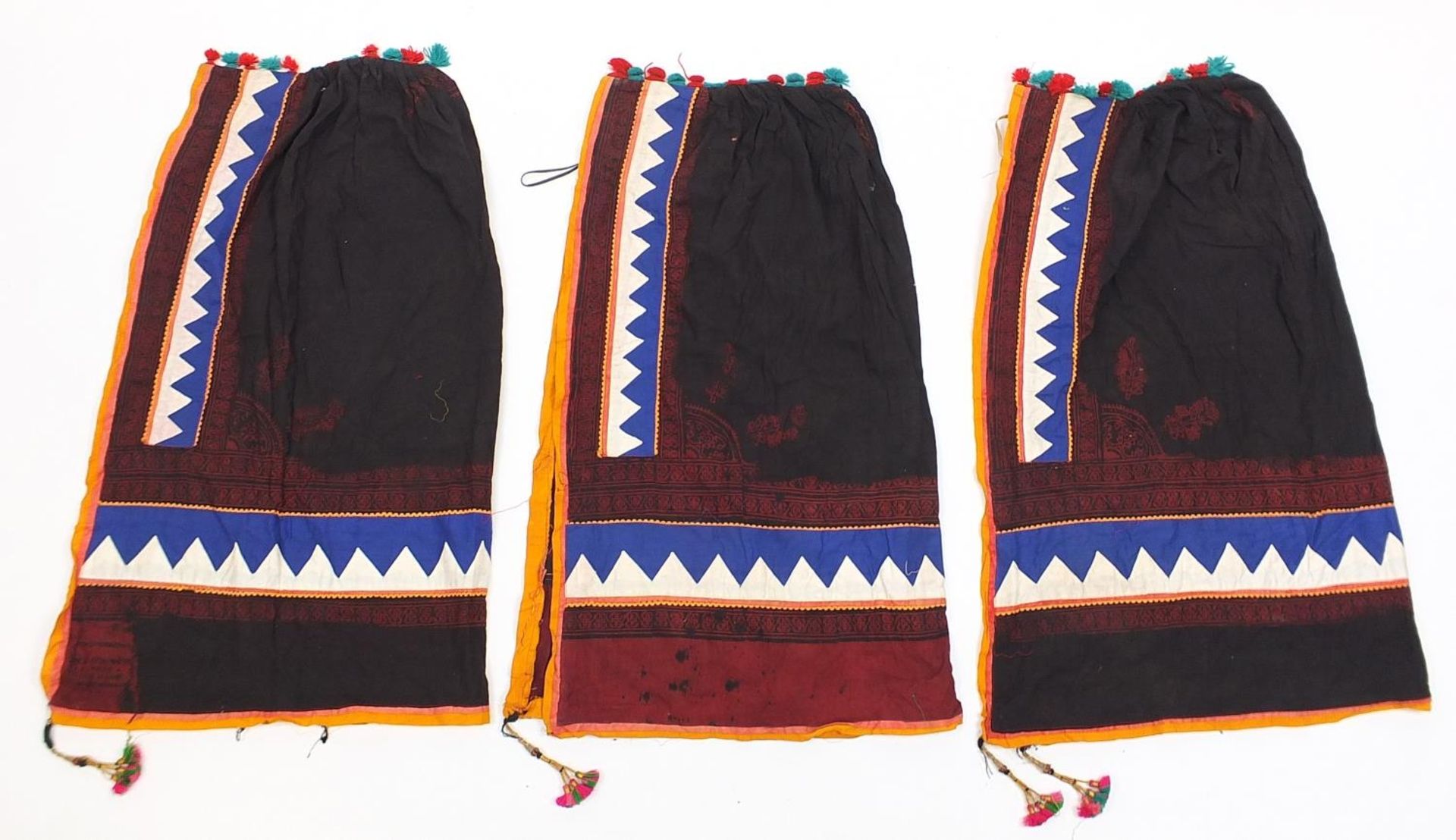 Three Middle Eastern or Indian textiles, possibly cloaks, each approximately 95cm high