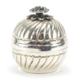 Circular silver box and cover with rose head knop, stamped 900 to the interior, 6cm high, 81.6g