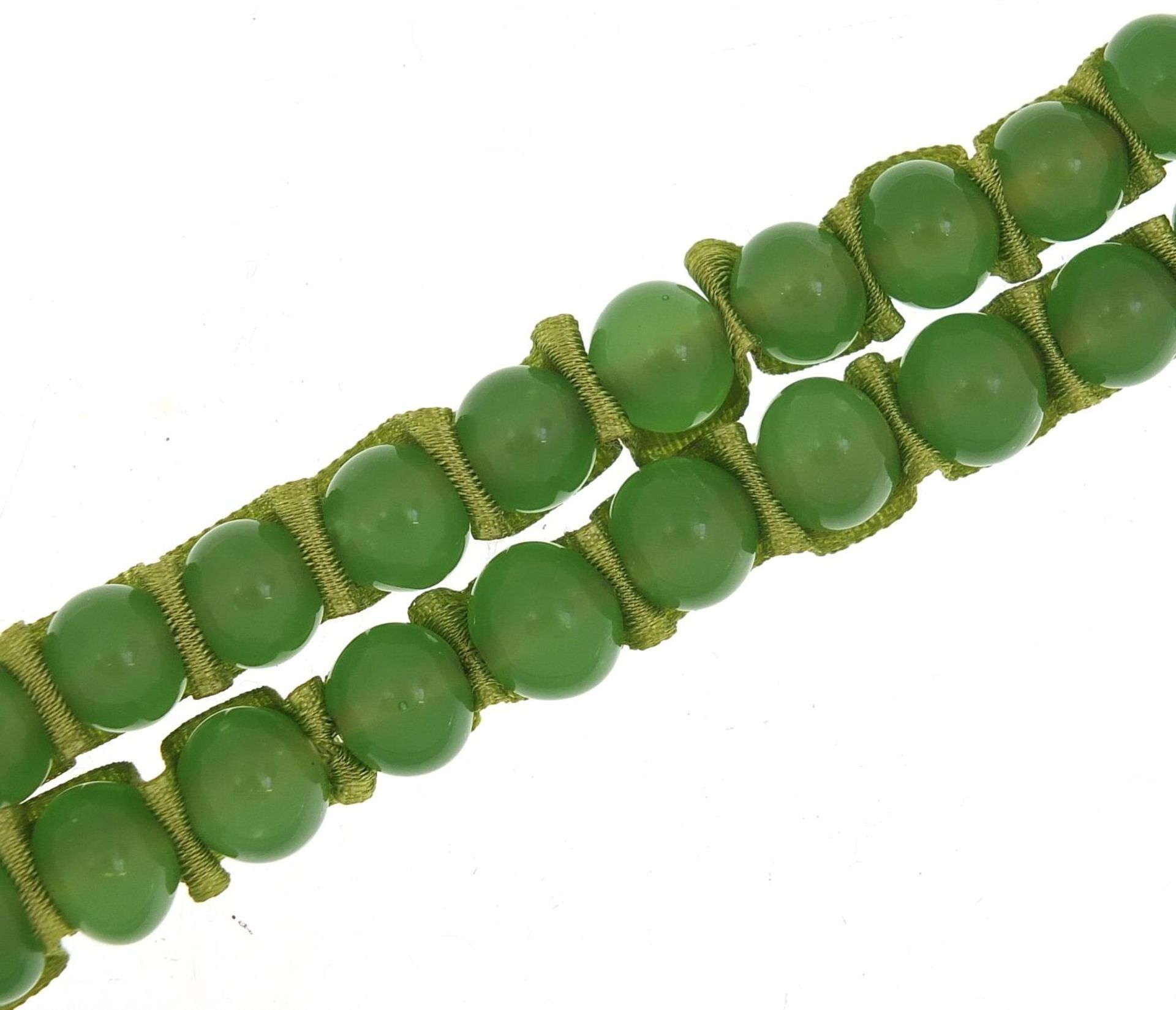 Chinese green jade bead necklace with silk ribbon, length of beads 56cm in length