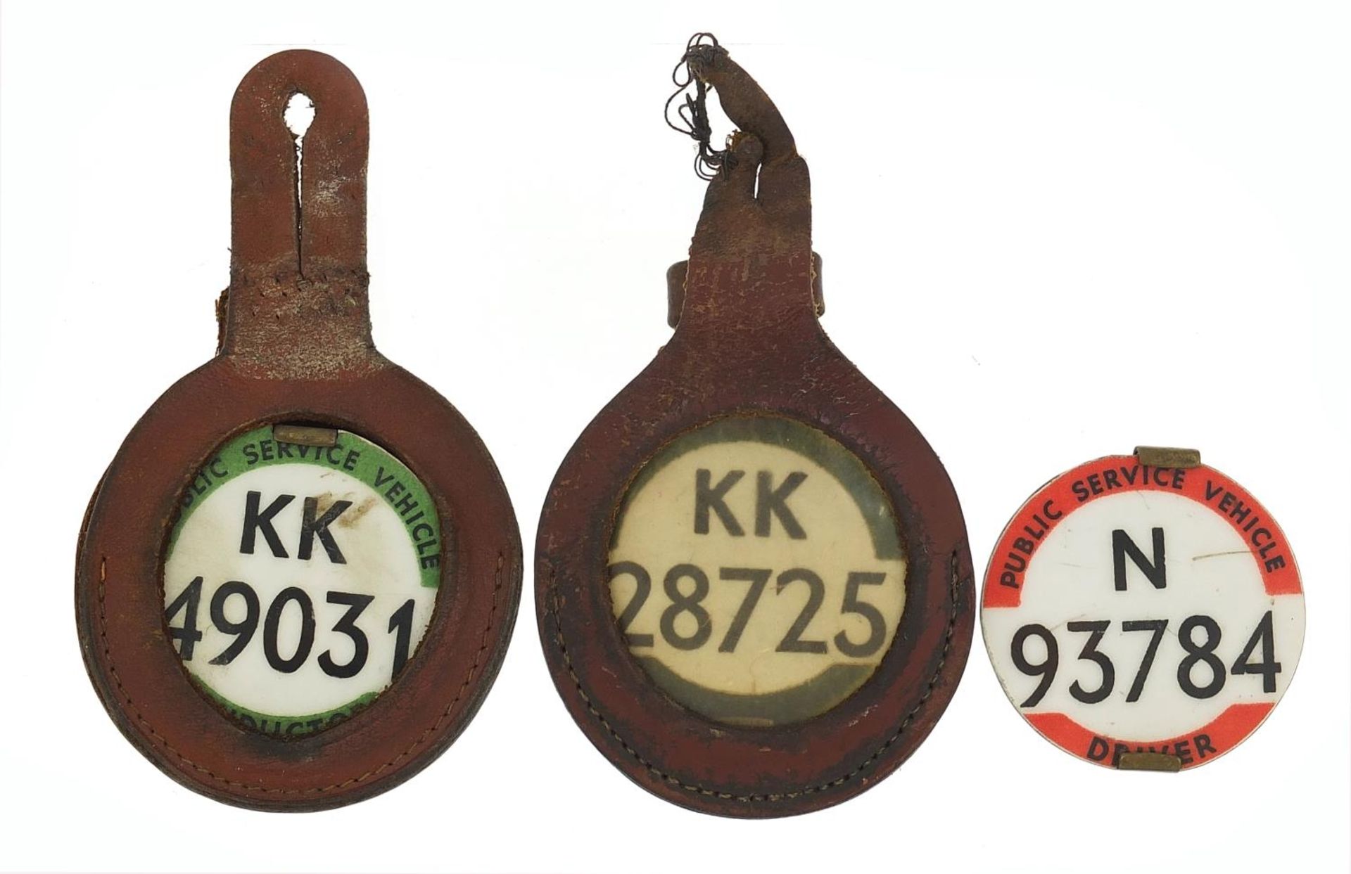 Three vintage Public Service Vehicle Driver badges