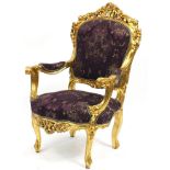 Ornate French style giltwood open armchair with purple floral upholstery, 112cm high