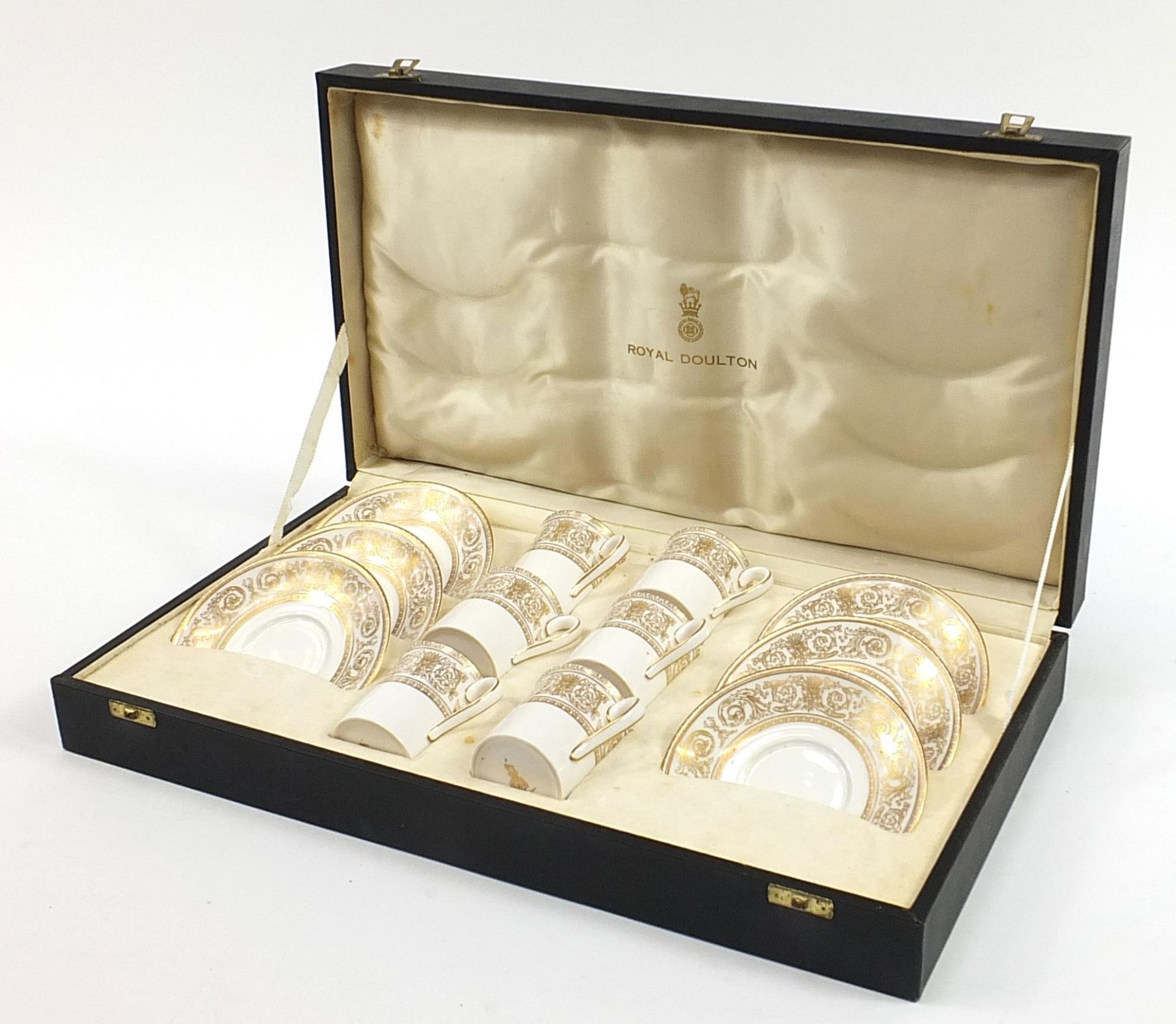 Set of six Royal Doulton coffee cans and saucers housed in a velvet and silk lined fitted case,