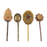 9ct gold acorn hatpin and three antique stickpins including one marked 9ct gold, the largest 12.