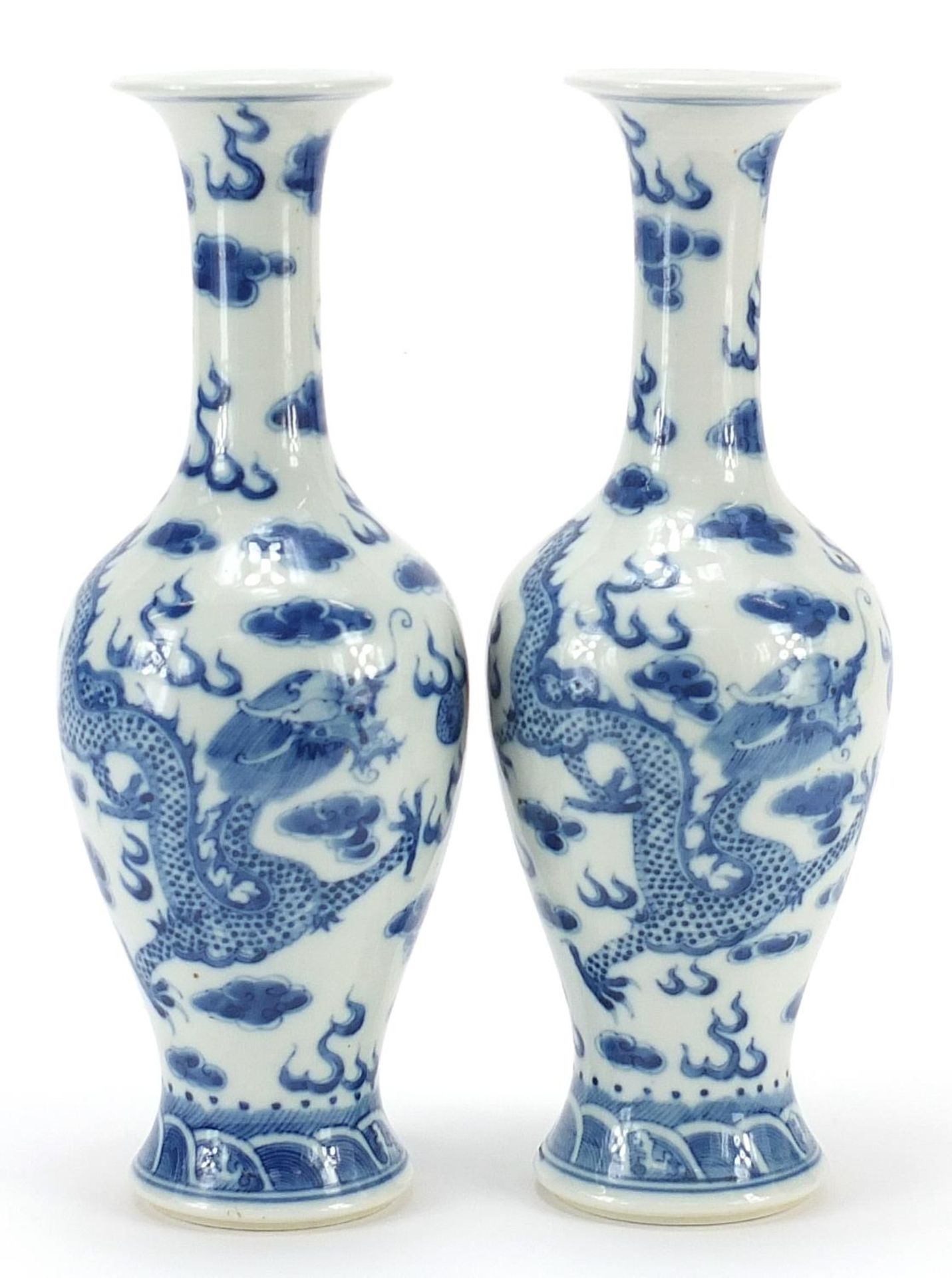 Pair of Chinese blue and white porcelain vases hand painted with dragons amongst clouds, four figure