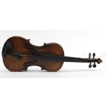 Old wooden violin with one piece back and case bearing a Joseph Guarnerius Fecit paper label dated