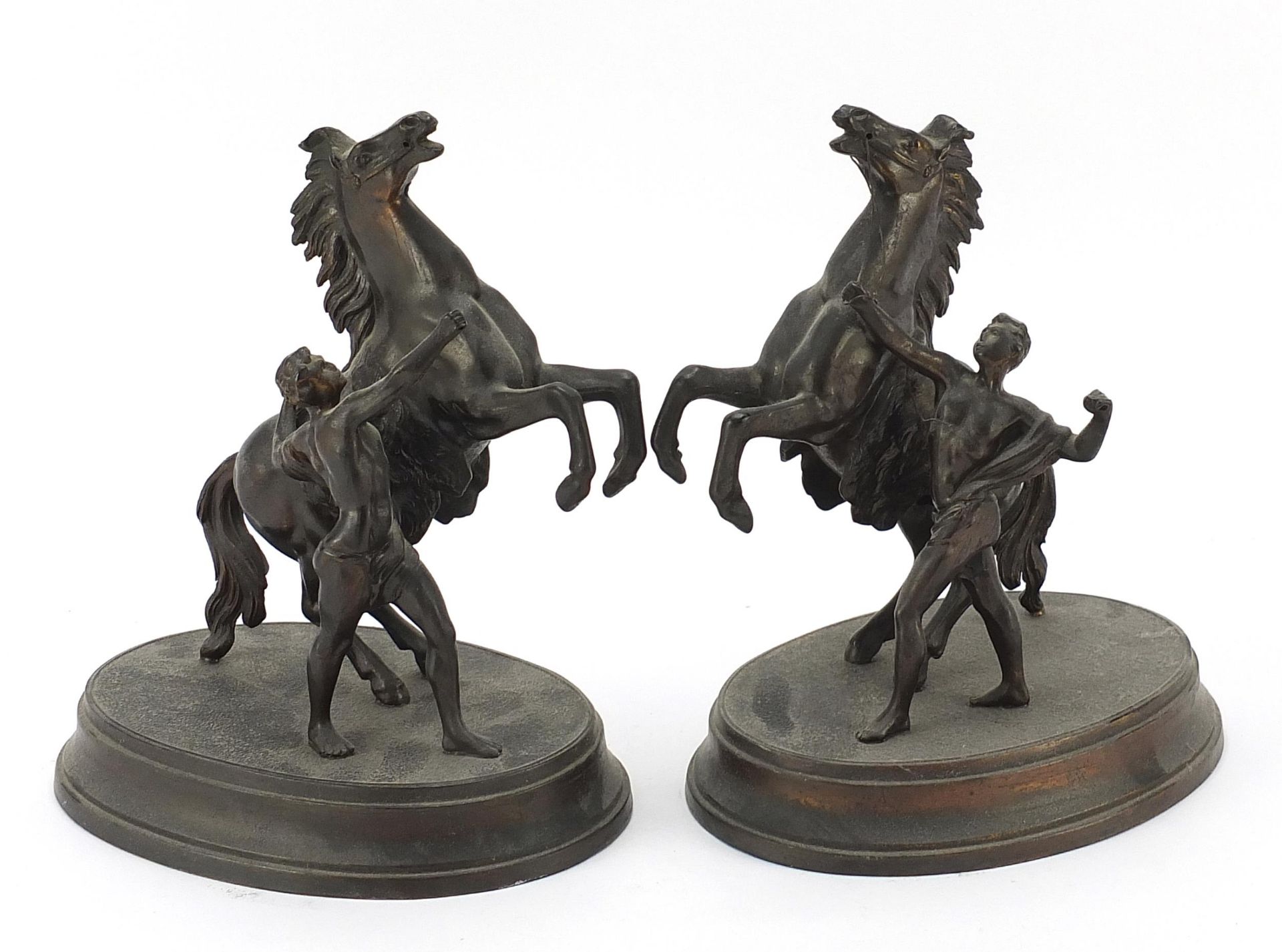 Pair of spelter Marley horse with trainer figures, 21.5cm high