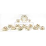 Edwardian teaware decorated with flowers including trios, milk jug and sandwich plate, the largest