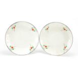 Pair of Art Deco porcelain plates with hand painted motifs, each 23cm in diameter
