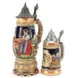 Two German pottery beer steins including a musical example decorated in relief with merry figures,