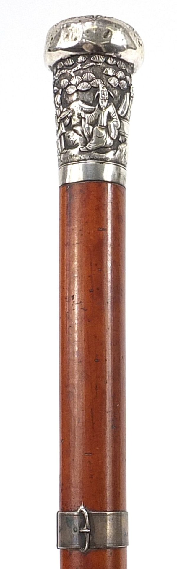 Malacca walking stick with unmarked silver mounts including Chinese pommel embossed with figures,