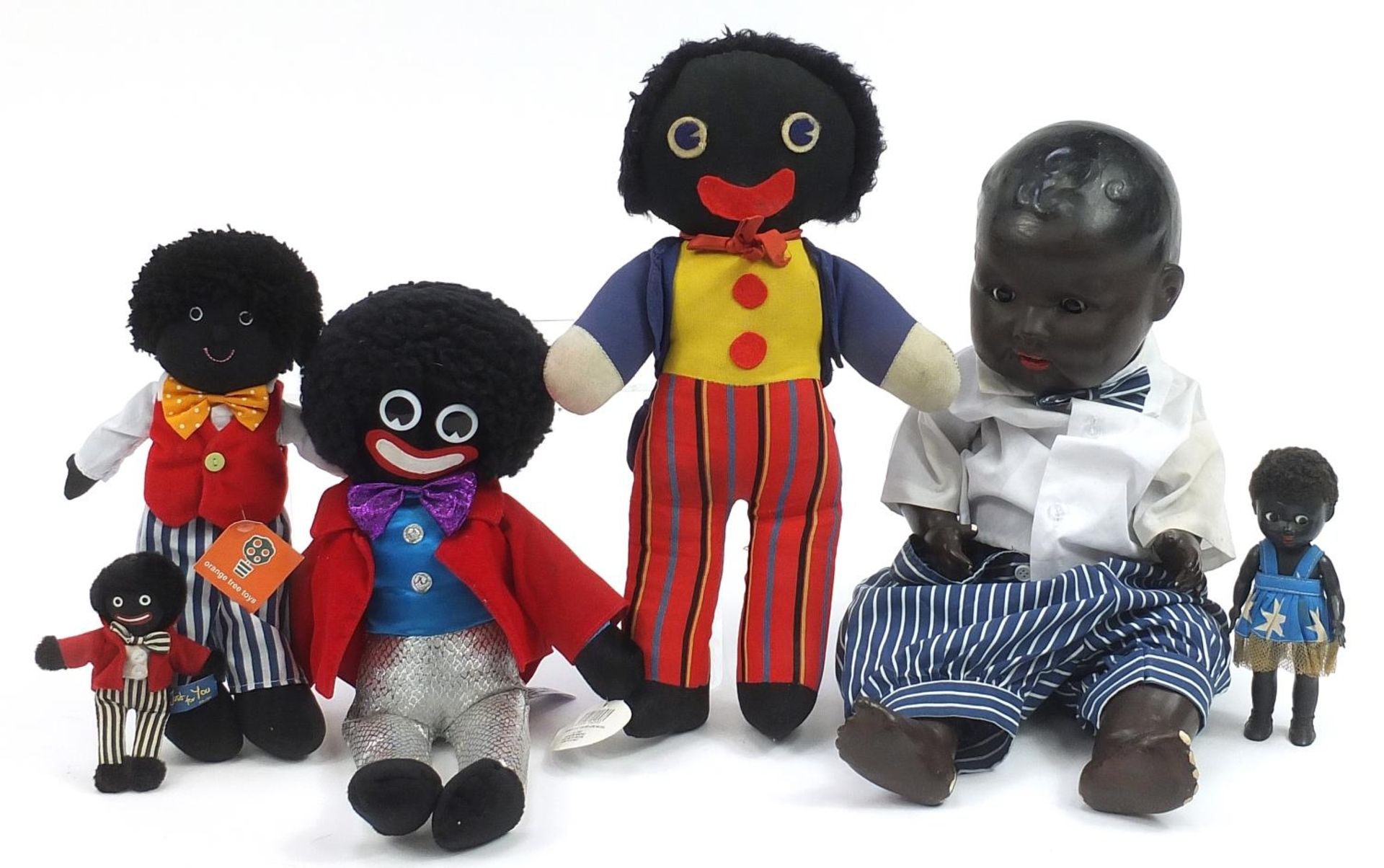 Large Armand Marseille black bisque headed doll, four soft toy Golly dolls and a miniature