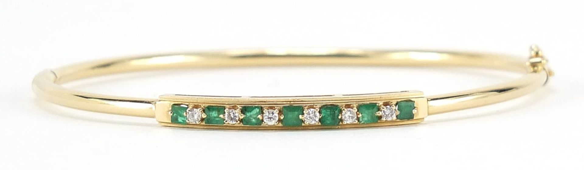 14ct gold emerald and diamond bangle, 6.3cm in diameter, 5.5g