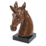 Louis Vuitton style bust of a unicorn raised on a square black slate base, 47cm high