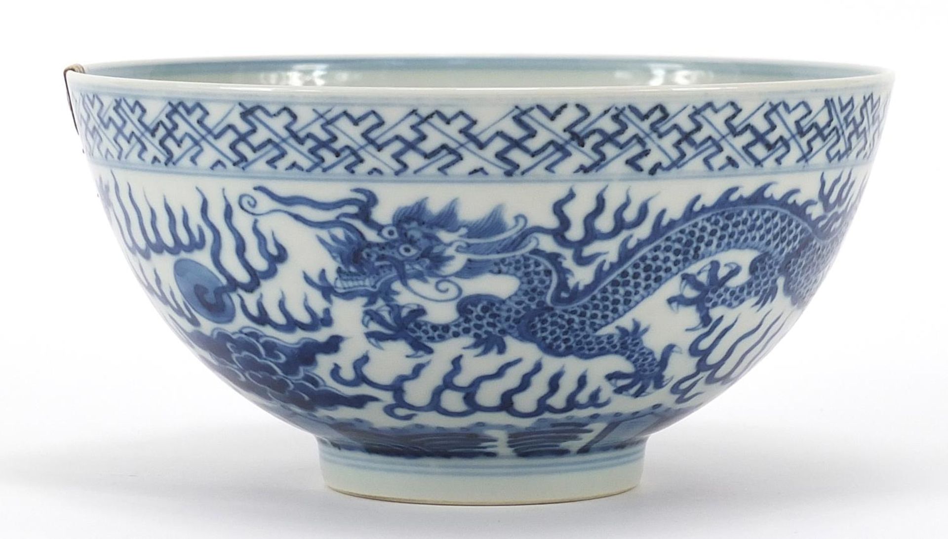 Chinese blue and white porcelain bowl hand painted with a dragon chasing a flaming pearl amongst