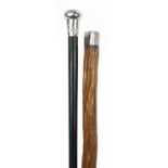 Two walking sticks with silver handles including an ebonised example, the largest 91cm in length