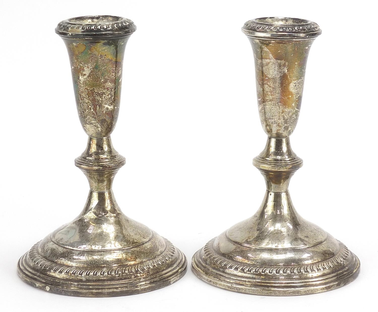 Pair of sterling silver weighted candlesticks, 14.5cm high, 770.0g