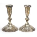 Pair of sterling silver weighted candlesticks, 14.5cm high, 770.0g