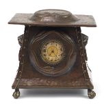 Arts & Crafts beaten copper mantle clock with lion mask ring turned handles embossed with two