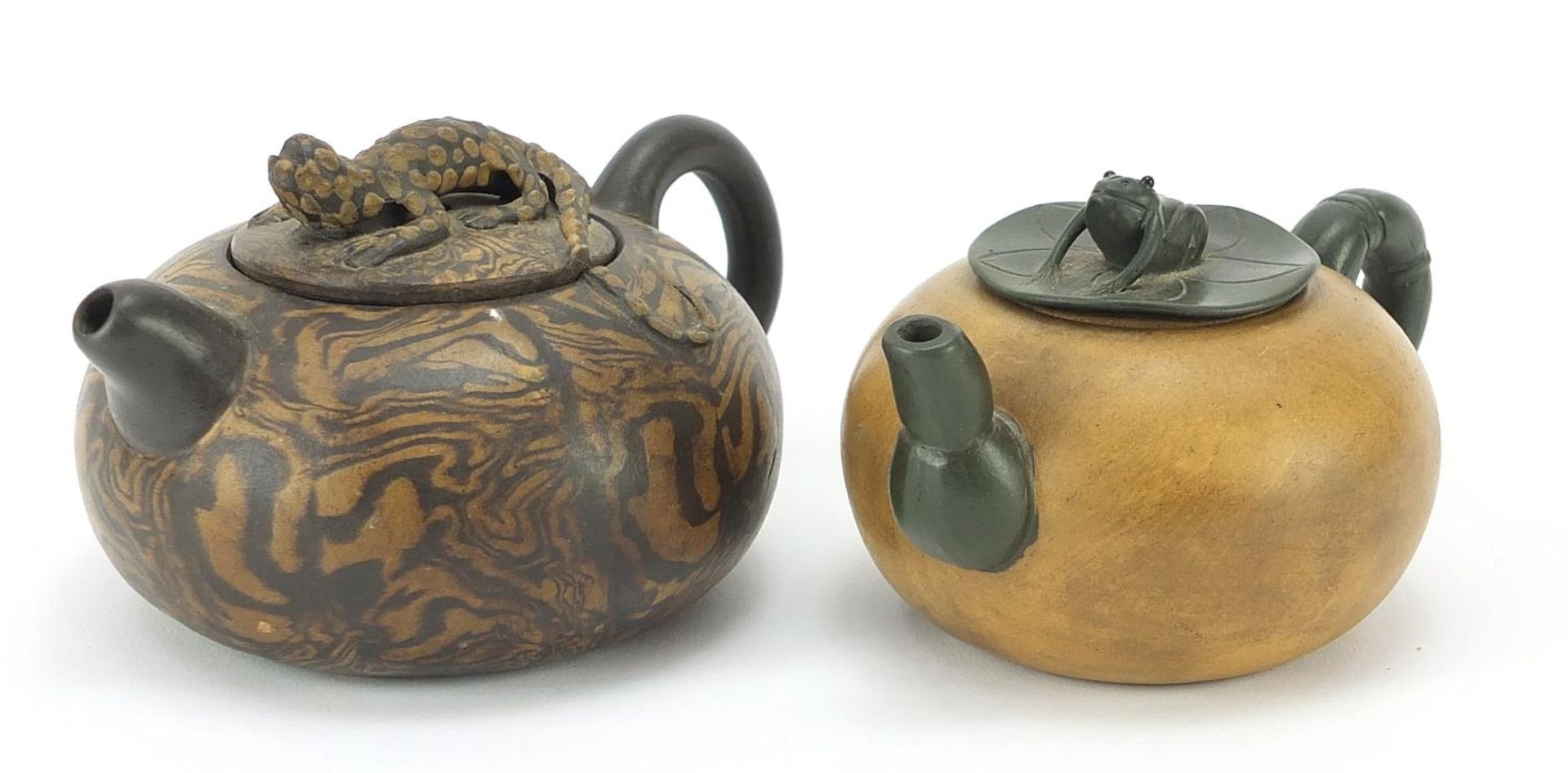 Two Chinese Yixing terracotta teapots including a marbleised example with lizard knop, the largest