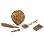 Tribal objects including a hand painted animal hide shield and musical instruments, the largest 50cm