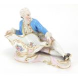 19th century porcelain figural sweetmeat dish in the form of a young man in Georgian dress, hand