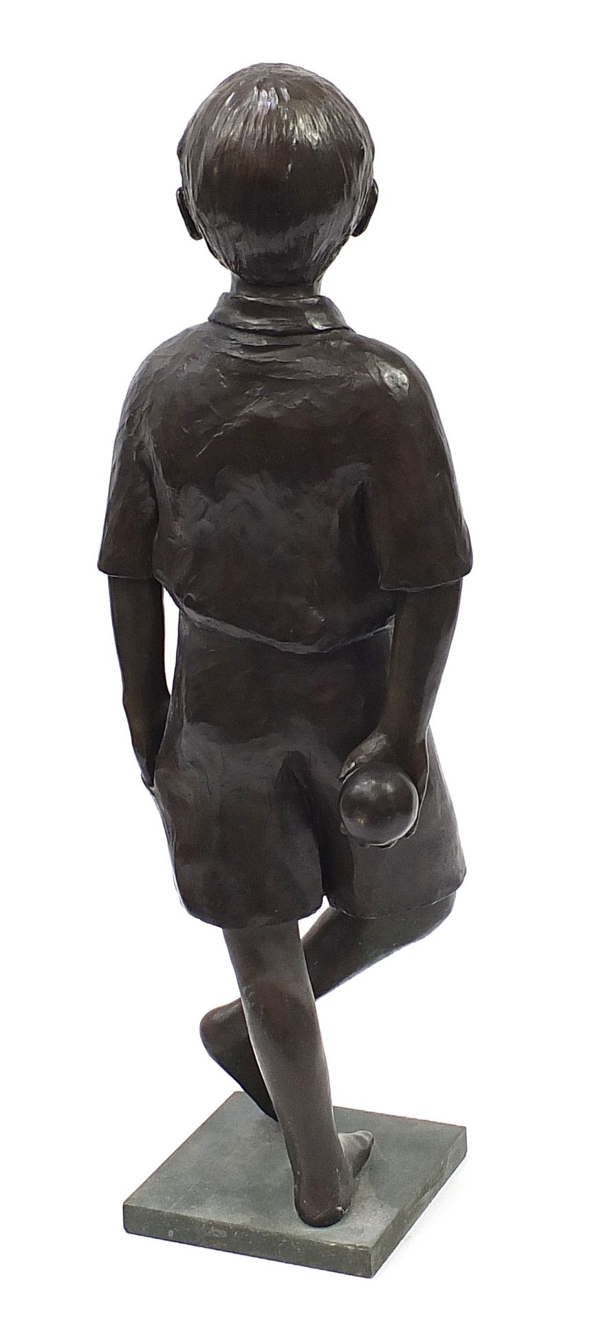 Judith Holmes Drewry, life size patinated bronze study of a young boy holding a ball, signed to - Image 2 of 4