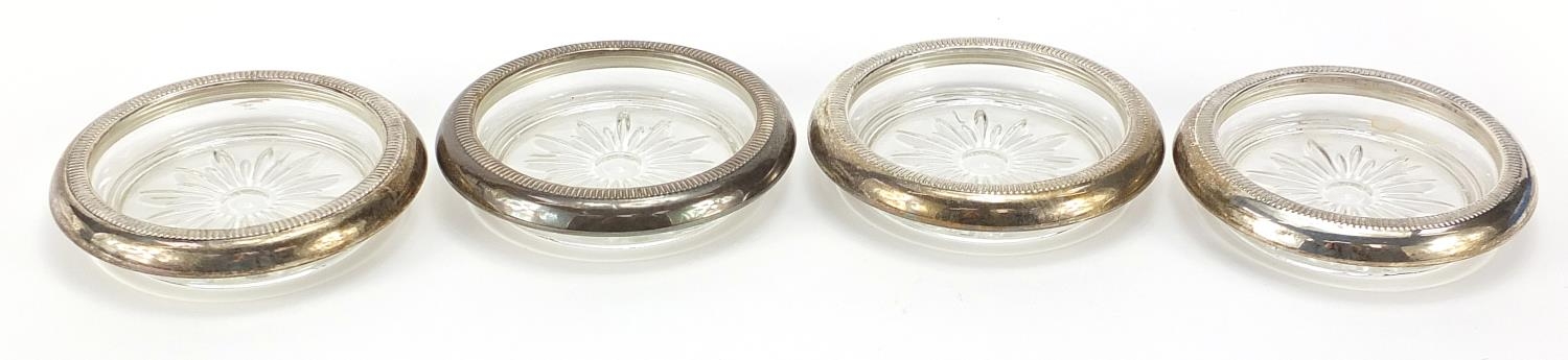 Set of four sterling silver mounted glass coasters, 9.5cm in diameter