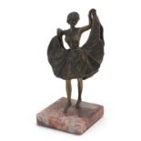 Patinated bronze figurine of an Art Deco dancer with lift up skirt, raised on a square marble