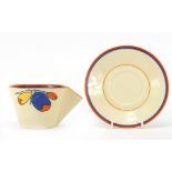 Clarice Cliff, Art Deco Bizarre block handled cup and saucer hand painted with fruit, the saucer