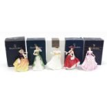 Five Royal Doulton figurines with boxes including Christmas Day 1999 and Autumn Breezes, each 20cm