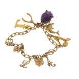 9ct gold charm bracelet with a selection of 9ct gold charms, unmarked gold charms and an amethyst