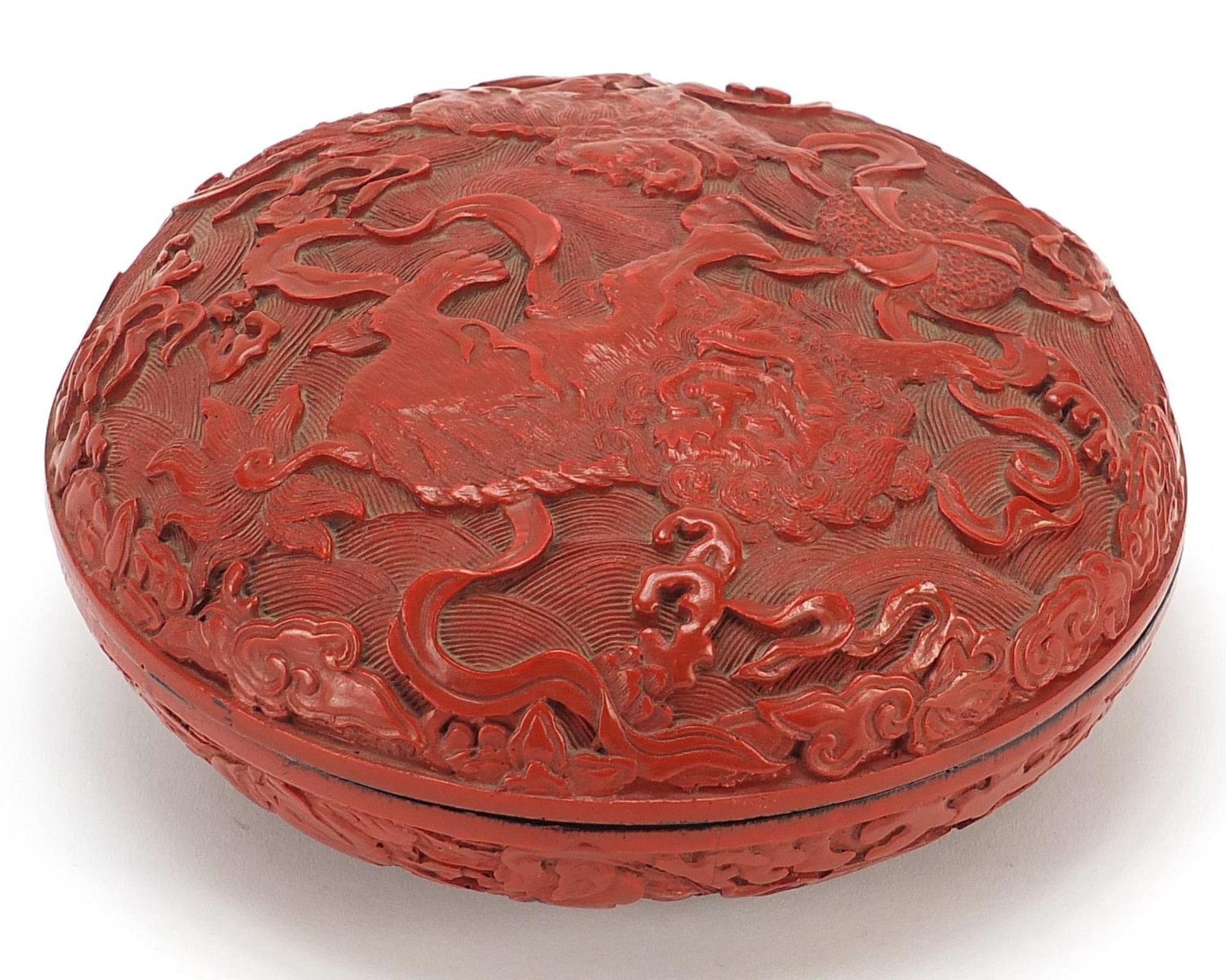 Chinese cinnabar lacquered bun box and cover carved with Foo dogs amongst clouds, 18cm in diameter - Image 2 of 3