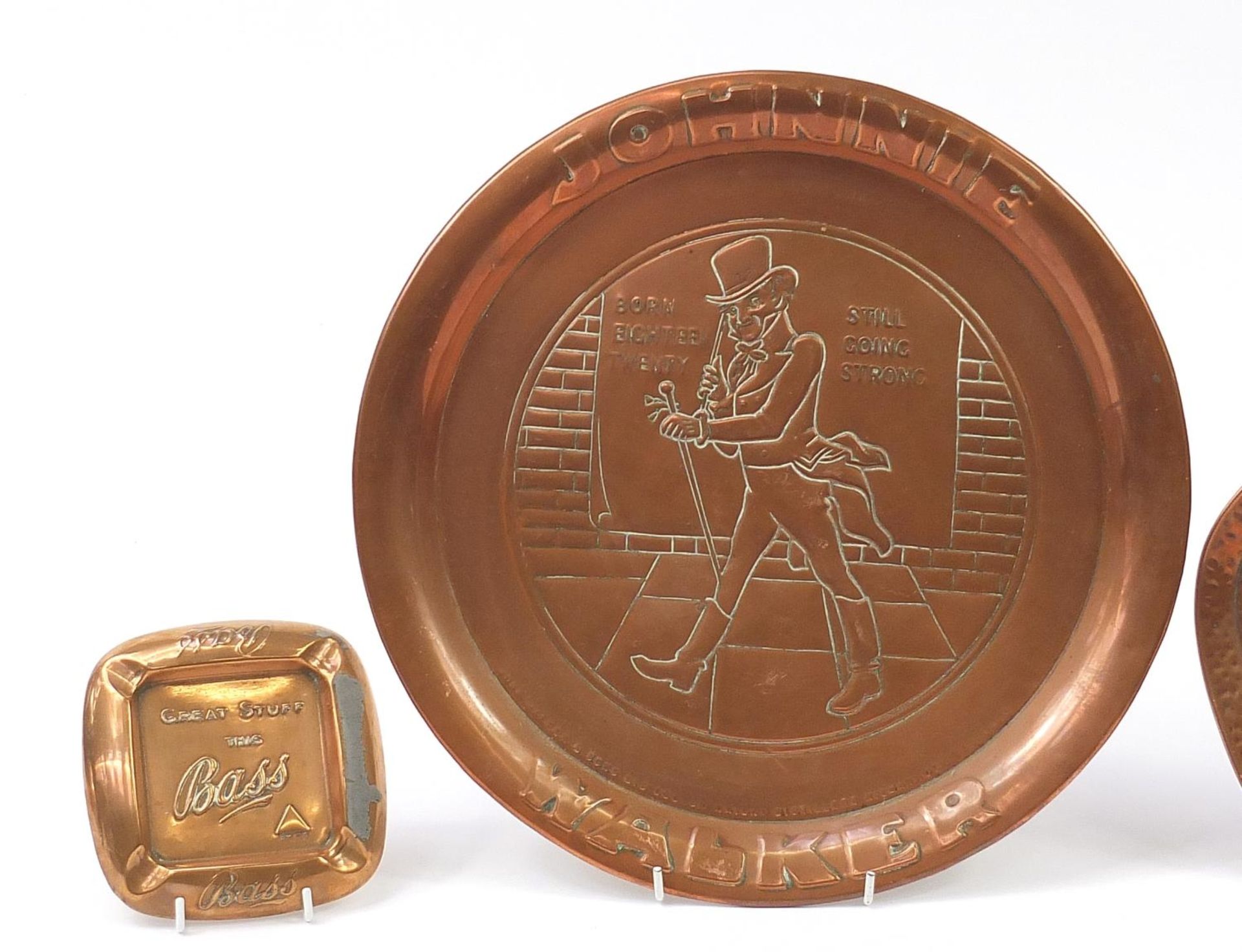 Four copper and brass advertising trays and ashtrays comprising Johnnie Walker, Teacher's Highland - Image 2 of 4