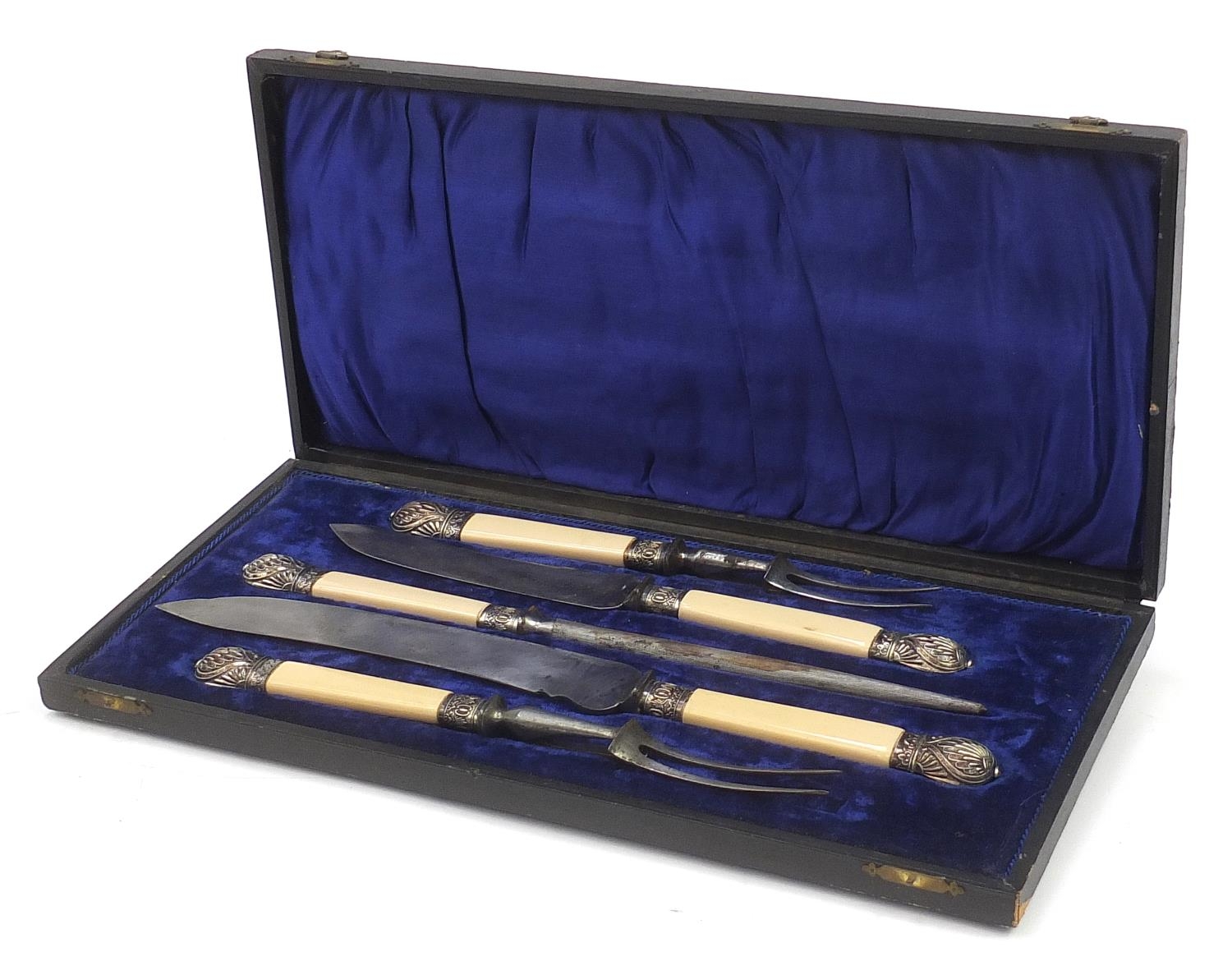 Five piece carving set with ivorine handles housed in a velvet and silk lined fitted case, the blade