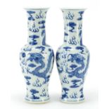 Matched pair of Chinese blue and white porcelain yen yen vases hand painted with dragons chasing a