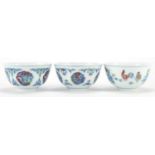 Three Chinese doucai porcelain tea bowls decorated with flowers and chicks, character marks to the