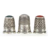 Three Charles Horner silver thimbles, two with hardstone tops, the largest 2.5cm high, total 16.2g