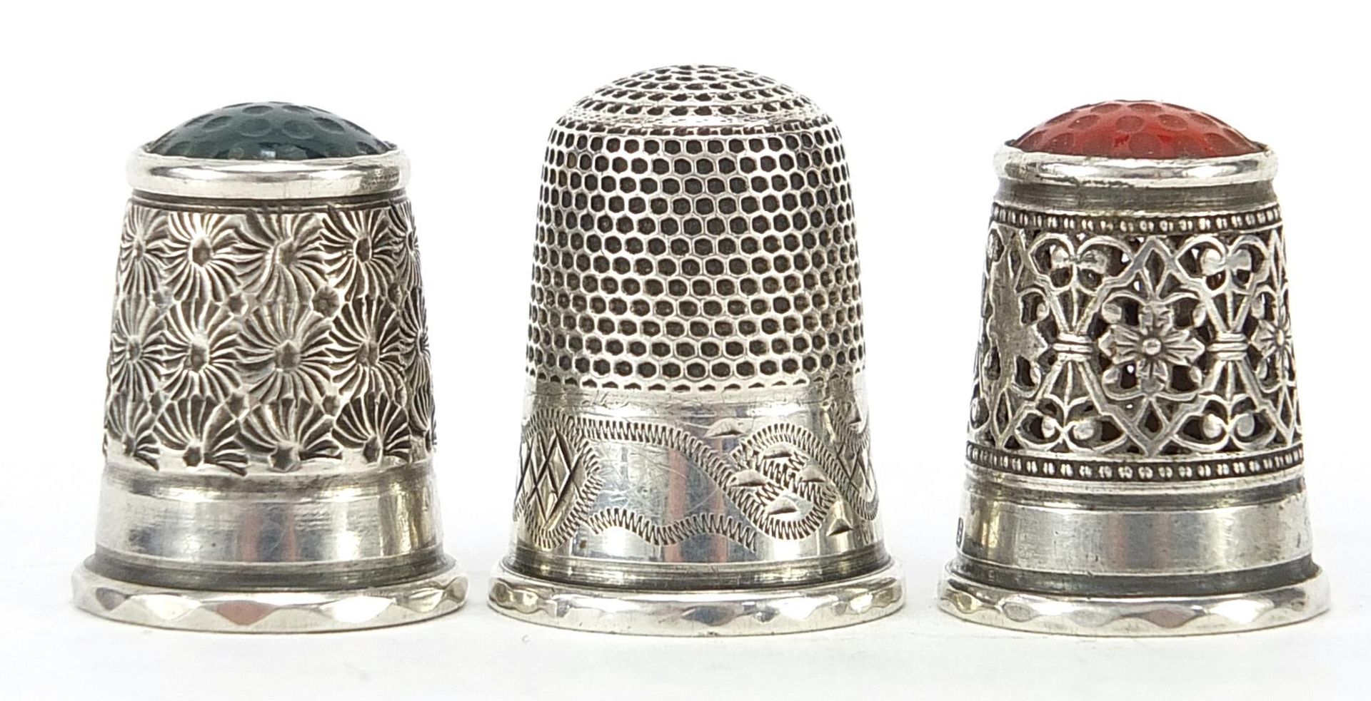 Three Charles Horner silver thimbles, two with hardstone tops, the largest 2.5cm high, total 16.2g