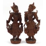 Pair of Balinese hardwood carvings of goddesses, the largest 58cm high