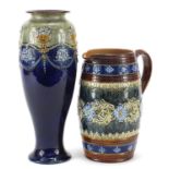 Doulton Lambeth stoneware jug and Royal Doulton stoneware vase hand painted with stylised flowers,