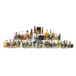 Large collection of alcohol miniatures and larger bottles of alcohol including Smirnoff vodka,