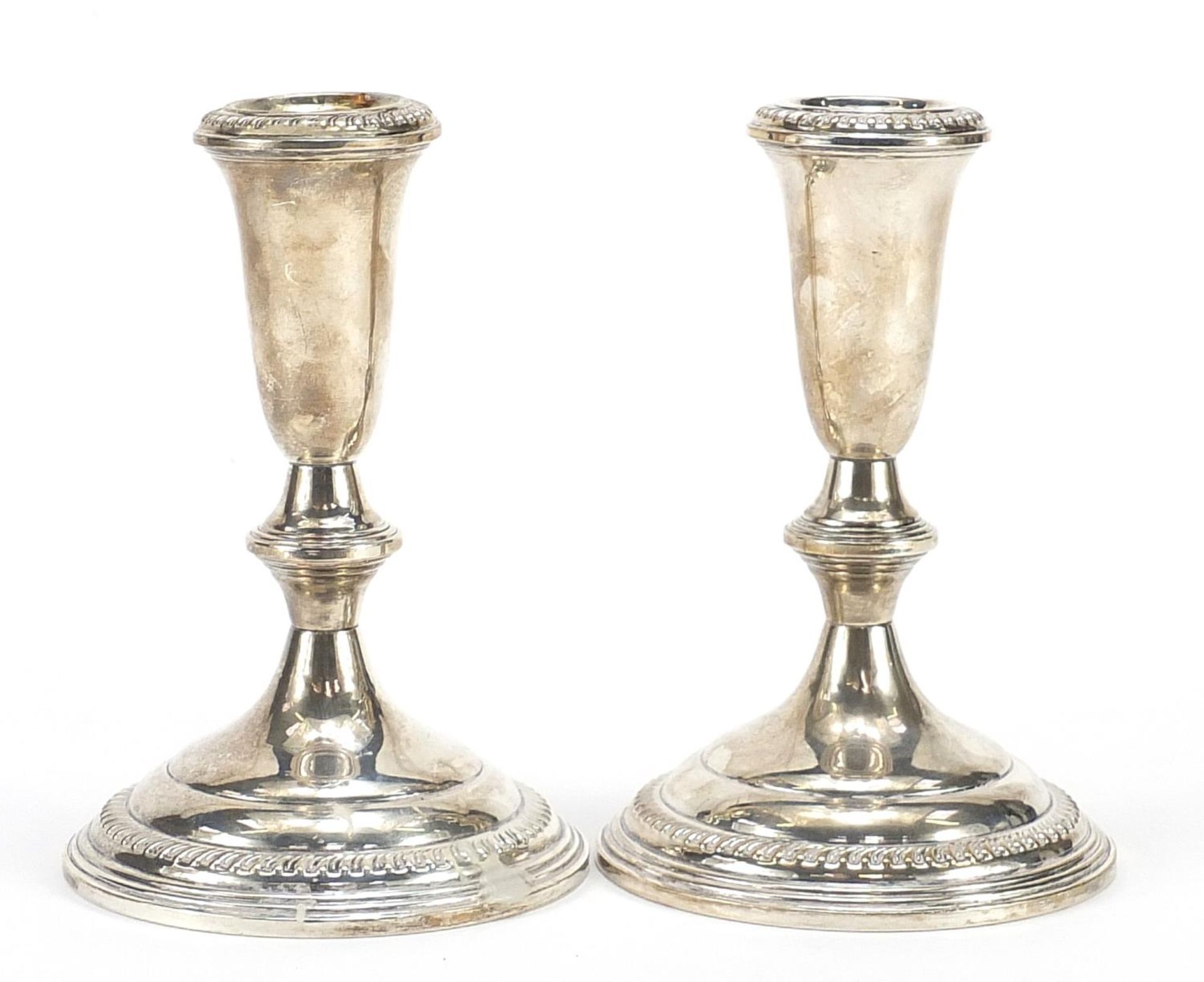 Pair of sterling silver weighted candlesticks, 14cm high, 775.0g