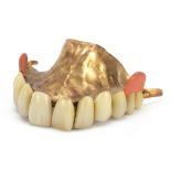 Unmarked gold denture, (tests as 18ct gold) total weight 22.0g