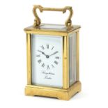Brass cased carriage clock with enamelled dial and Roman numerals inscribed Strongithasm of