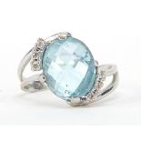 18ct white gold blue stone and diamond crossover ring, possibly aquamarine, size N, 5.2g