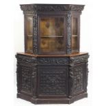 Antique Jacobean style china cabinet profusely carved with Putti and foliage, 213cm H x 166cm W x