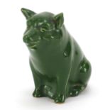 Pottery model of a seated pig having a green glaze, possibly Scottish, 9cm high